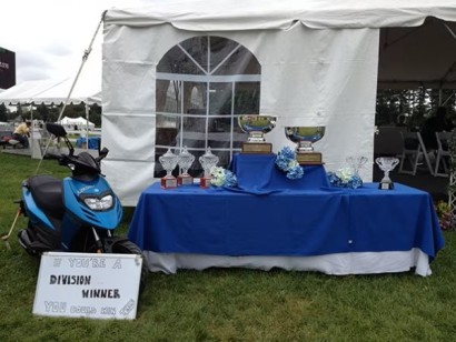 horse show trophies and a scooter on display
