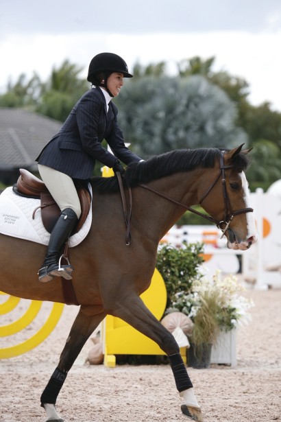 Jumper horse and rider trotting in show ring