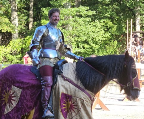Knight in burgundy on dark horse