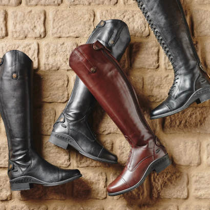 Laydown view of different types and colors of tall riding boots