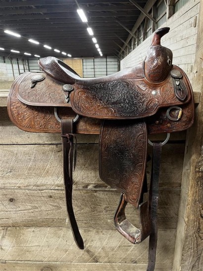 A clean medium oil western saddle facing to the right