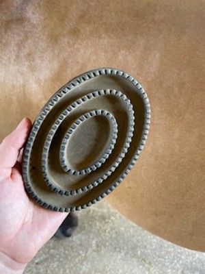 A rubber curry comb for horses.