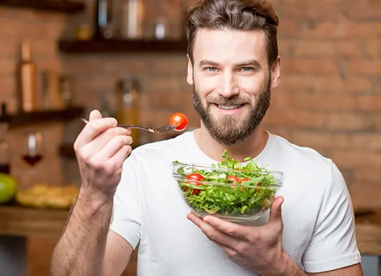 man eating a salad