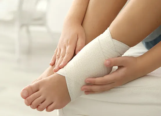 Person with their ankle wrapped from a sprain