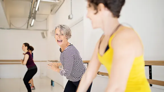 Two women doing exercise class having fun