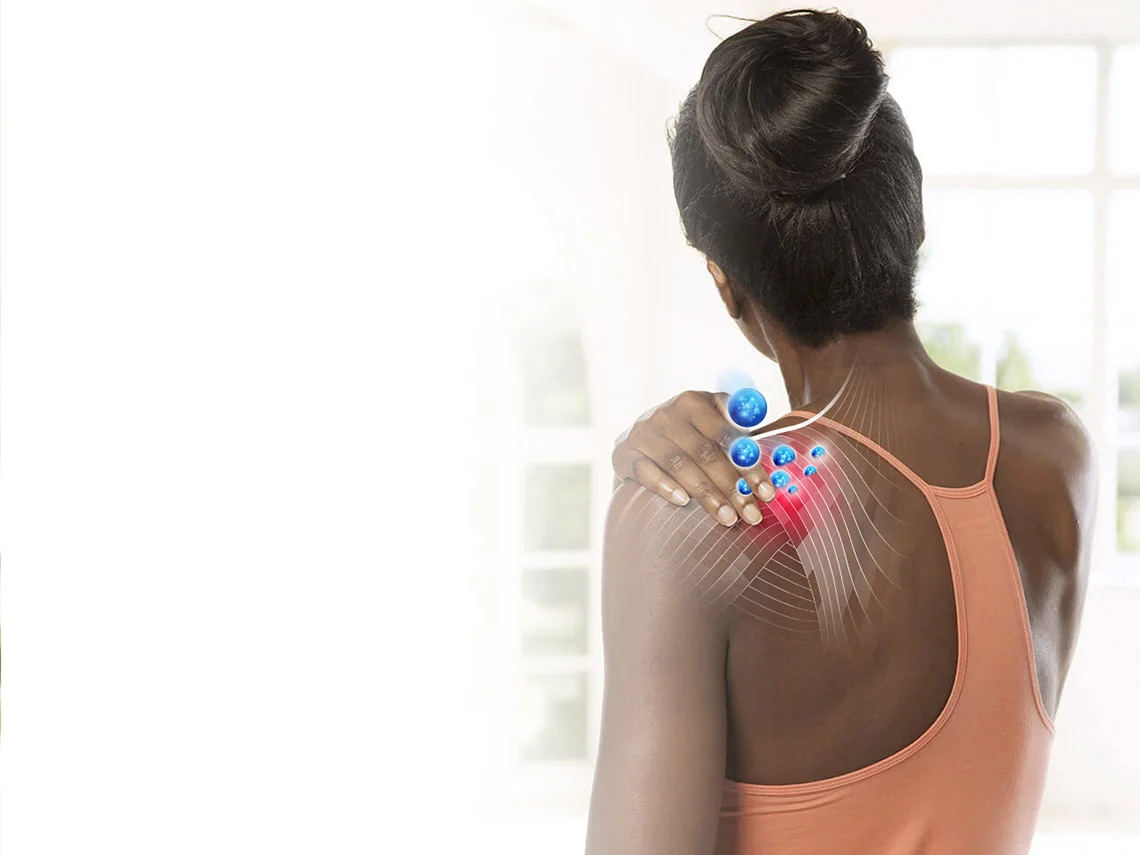  Woman touching shoulder which is being acted on by Voltaren science