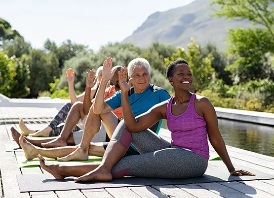  Five people outside doing yoga poses