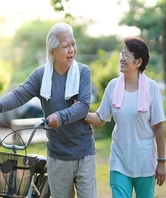  Older active couple walking together after exercising