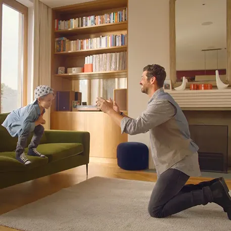 Father ready to catch his son who is jumping