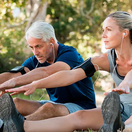A man and women stretching their backs in the garden