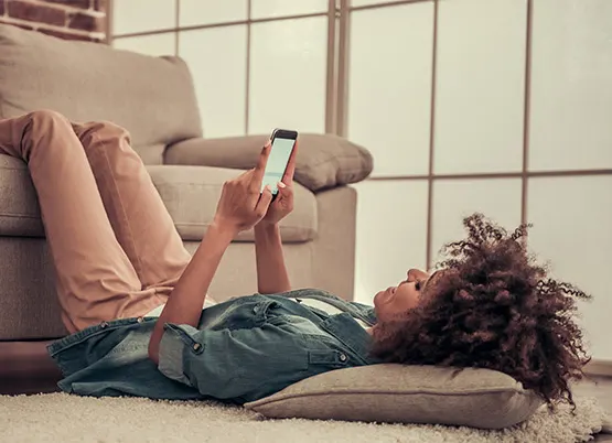 Woman laying on the floor with her feet on the sofa