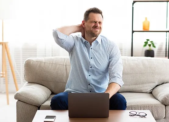 A man with a laptop working from home and