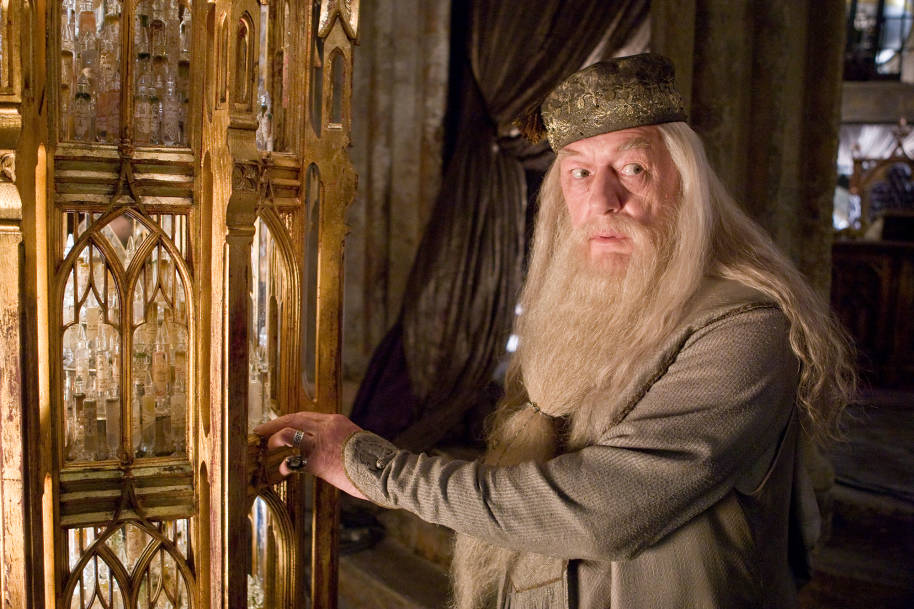 Albus Dumbledore in his office by the cabinet that contains memories