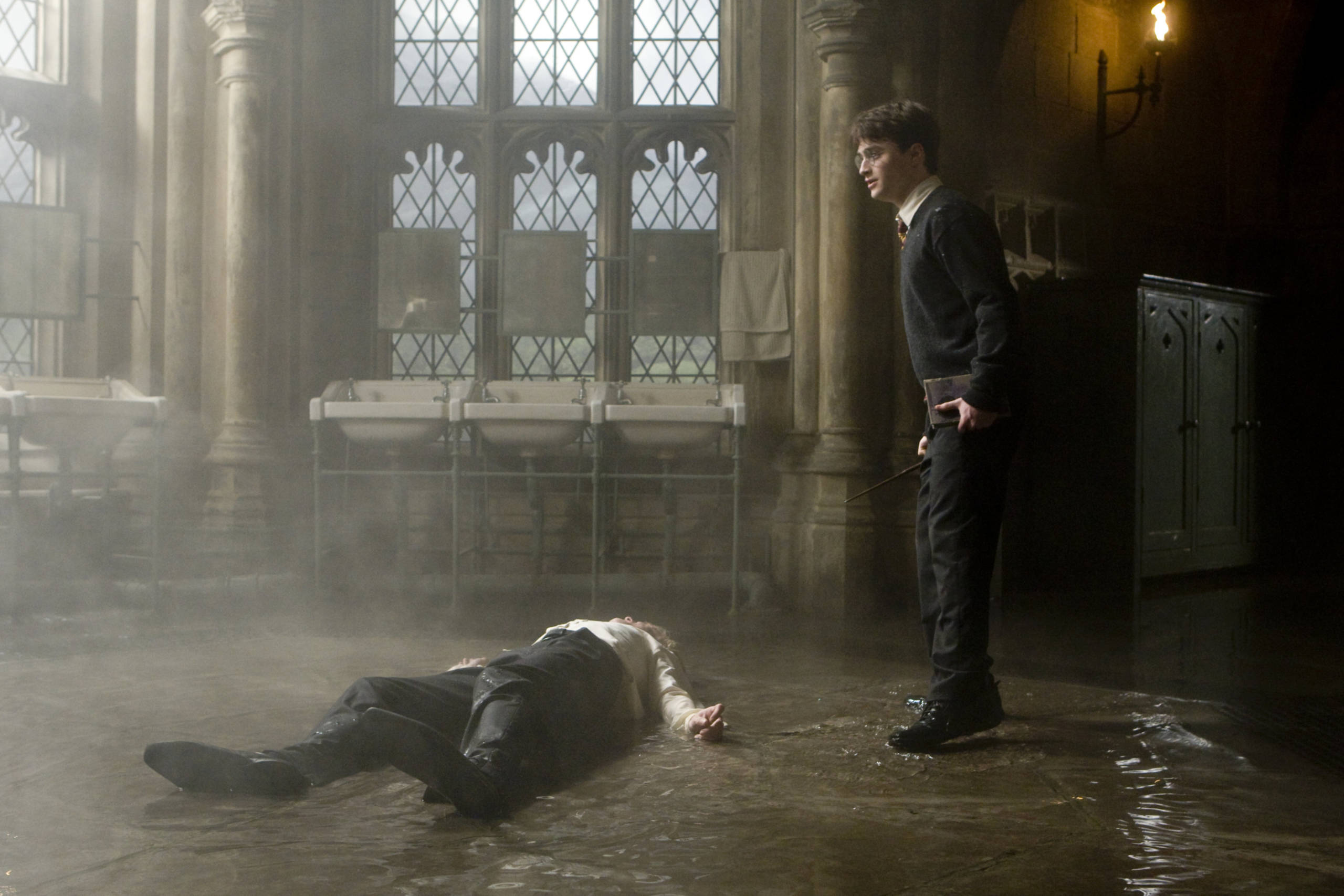 Draco lying on the bathroom floor after Harry's curse 