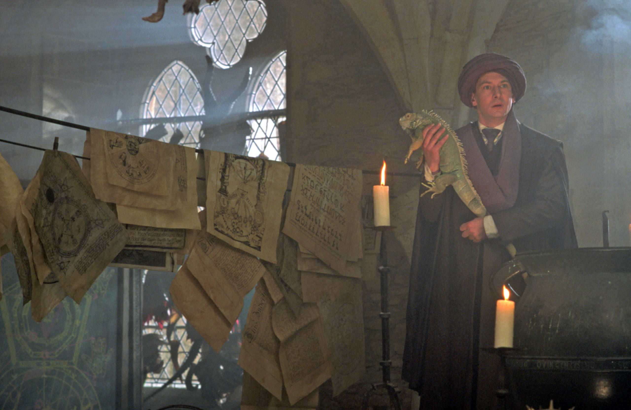 Quirrell teaching in his classroom with a lizard