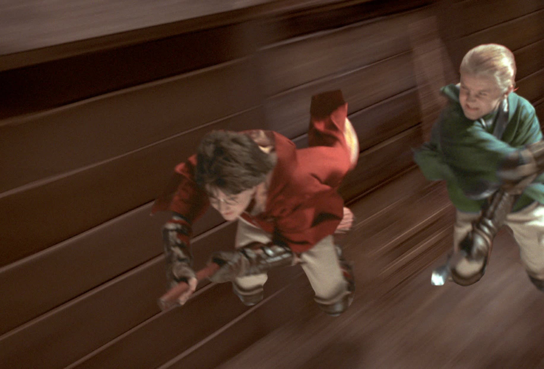 Harry and Draco race to the snitch in a quidditch match 
