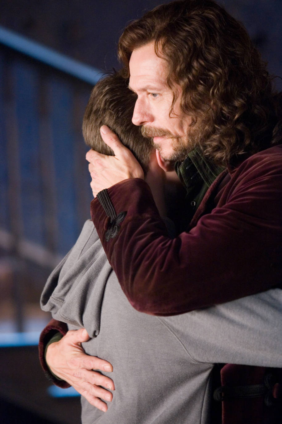 Sirius hugs Harry in Grimmauld Place.