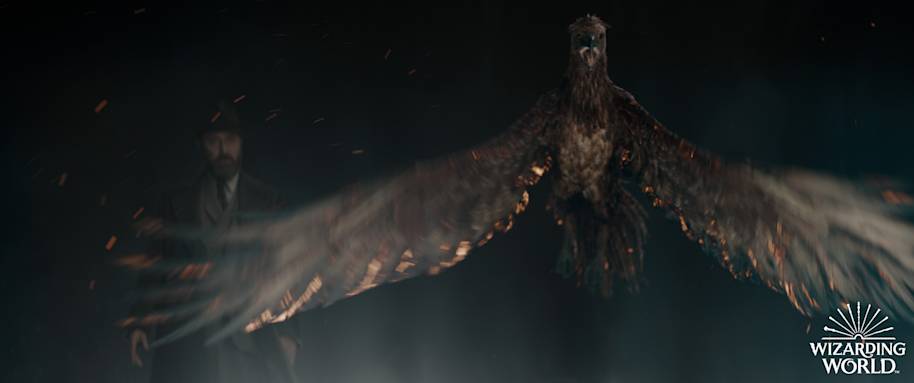 A phoenix spreading its wings while flying in front of Albus Dumbledore