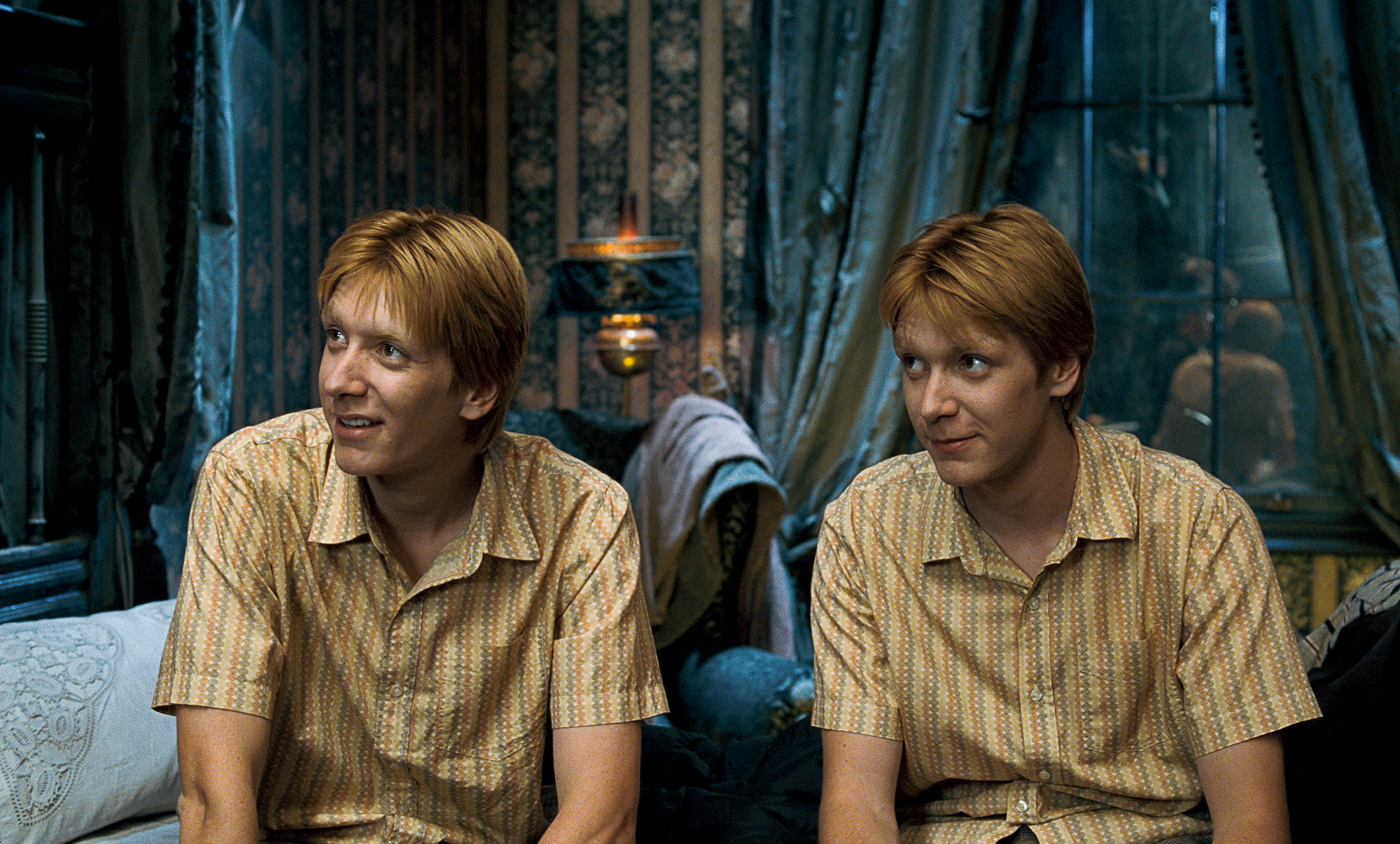 Fred and George sat down in Grimmauld place, wearing matching shirts and smirking.