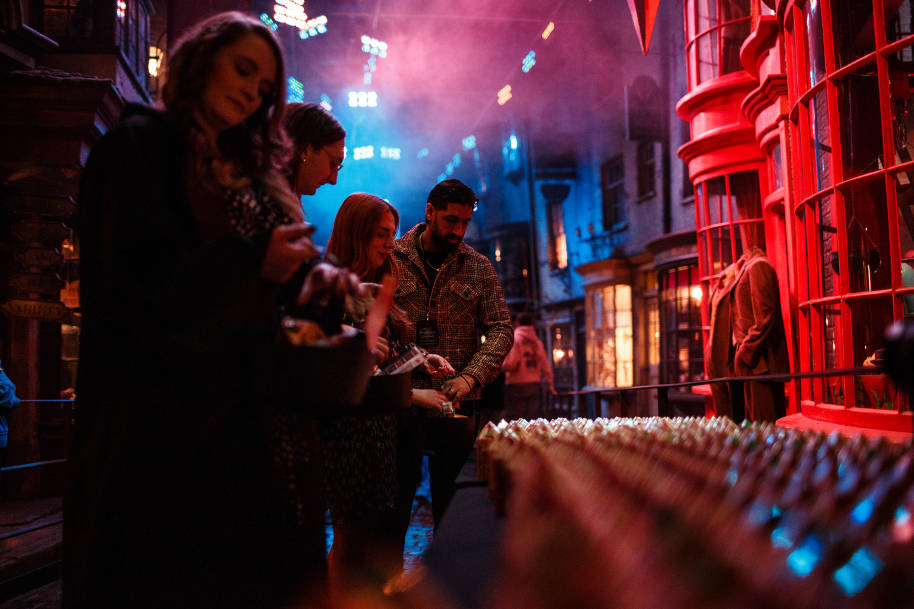 Fans standing at a trick or treat station at the Studio Tour in Diagon Alley.