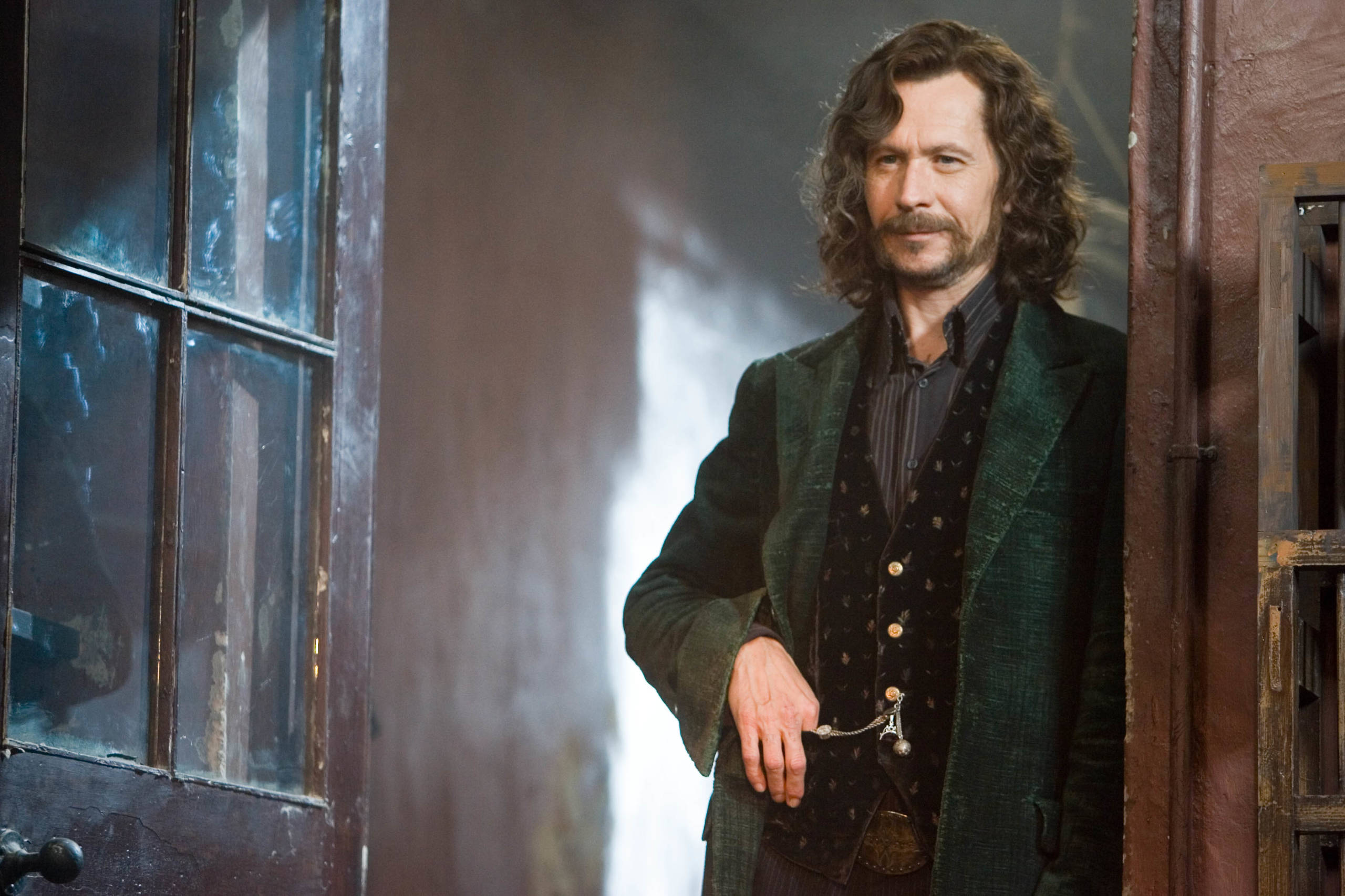 Sirius Black standing in doorway smiling