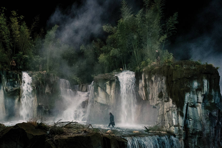 A waterfall in a jungle in China at night.