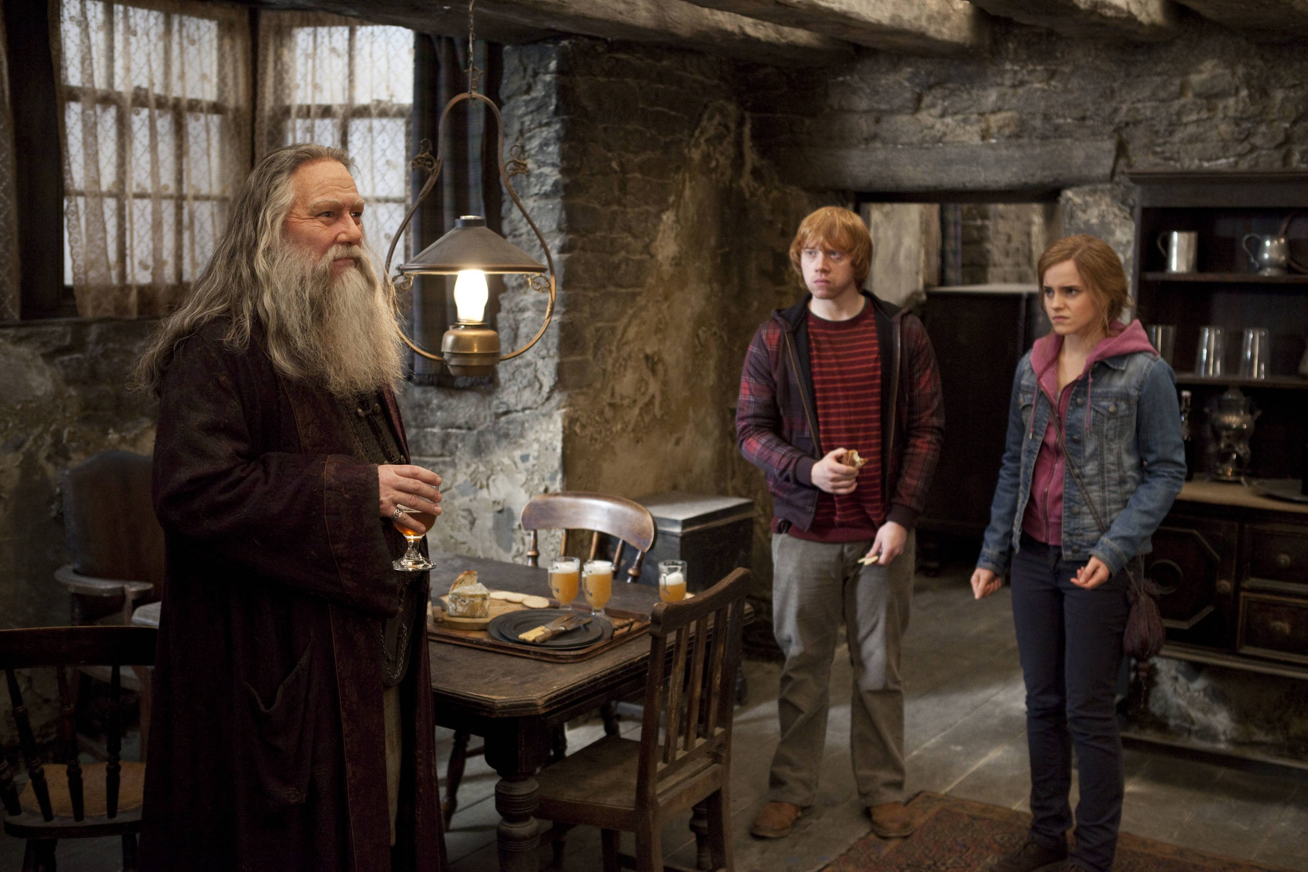 Aberforth Dumbledore standing in the Hog's Head Inn with Ron and Hermione