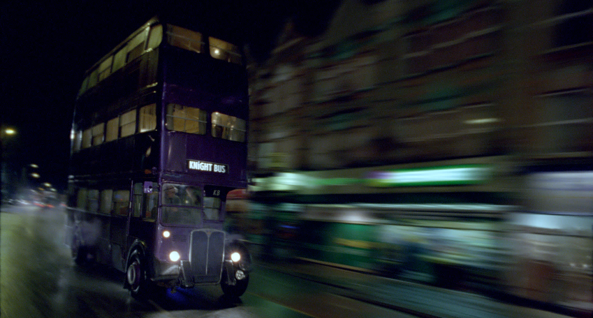 The Knight Bus being driven at speed at night.