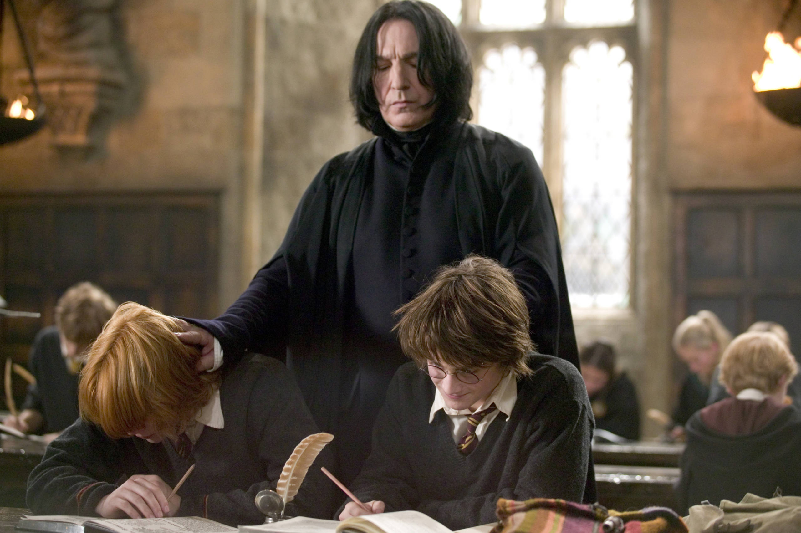 Snape pushes Harry and Ron's heads down in the Goblet of Fire.