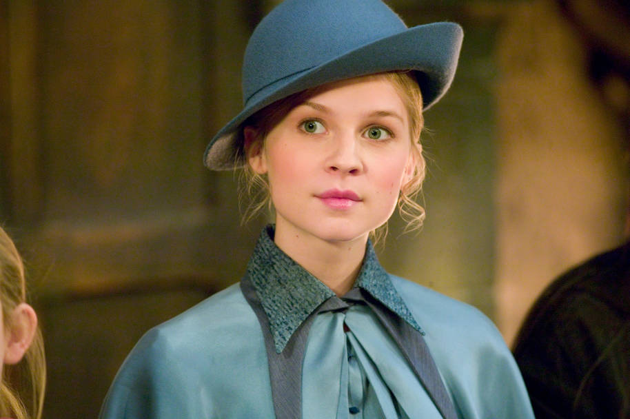 A close up of Fleur Delacour. She is wearing her Beauxbatons uniform and is slightly smiling.