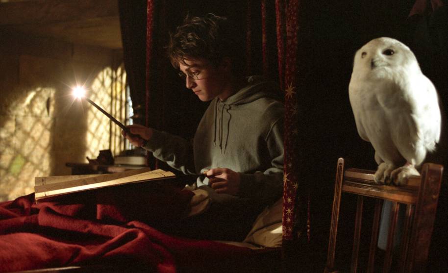 Harry looking at the Marauders Map in his dormitory