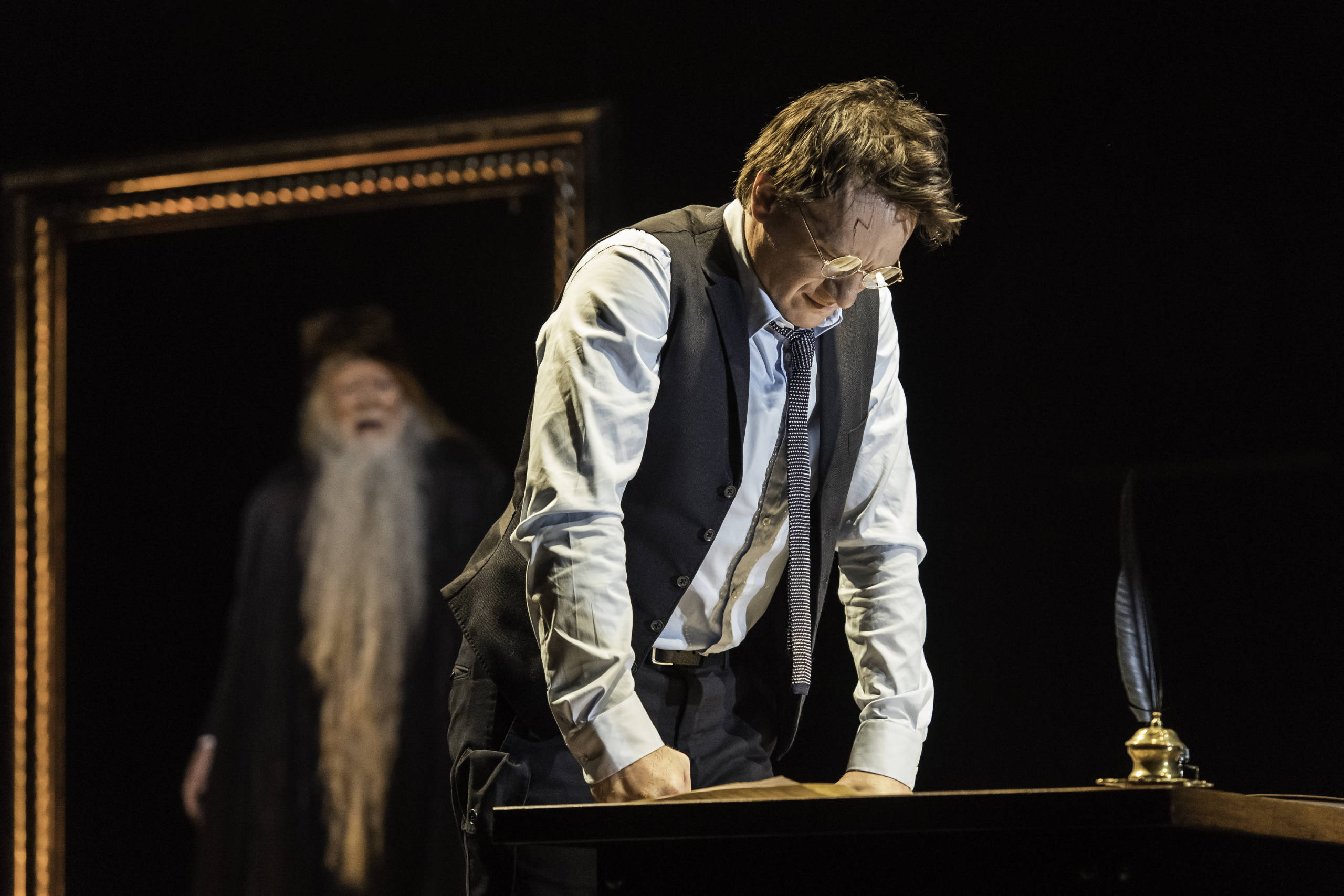 Jamie Parker as Harry Potter on stage, with Albus Dumbledore's portrait in the background