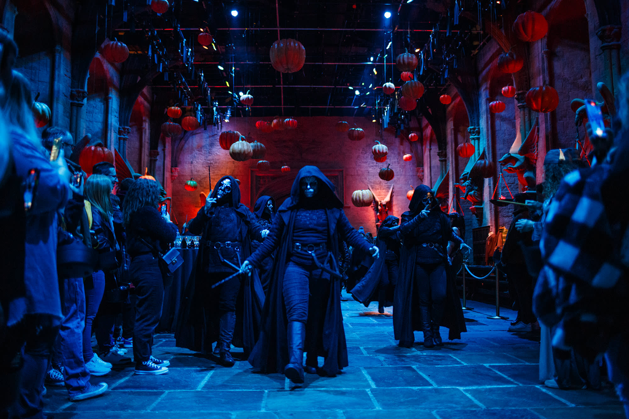 A group of Death Eaters walking through the Great Hall at the Studio Tour under the floating pumpkins