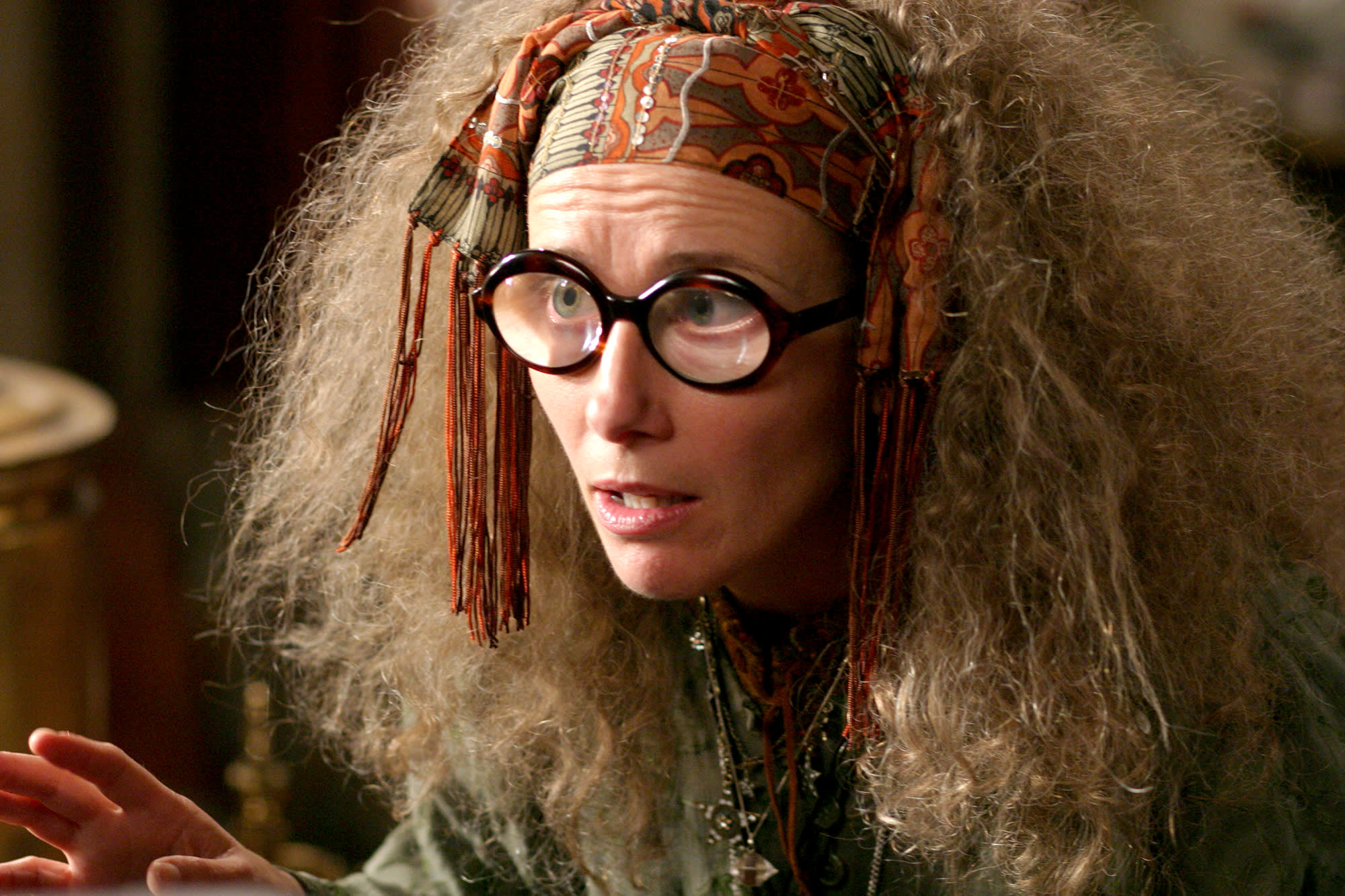 A close-up shot of Professor Trelawney wearing her signature glasses