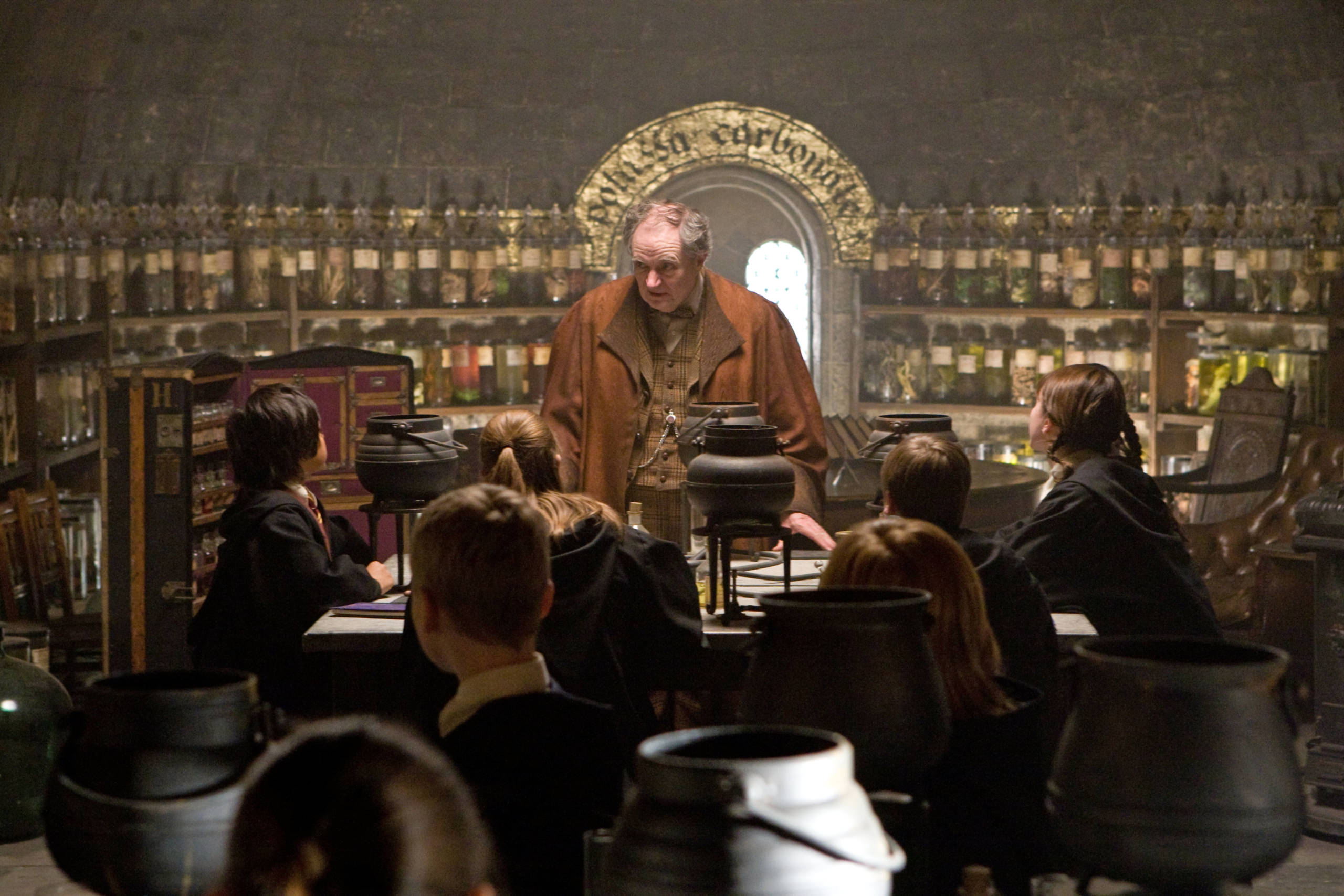 Slughorn teaches his Potions class.
