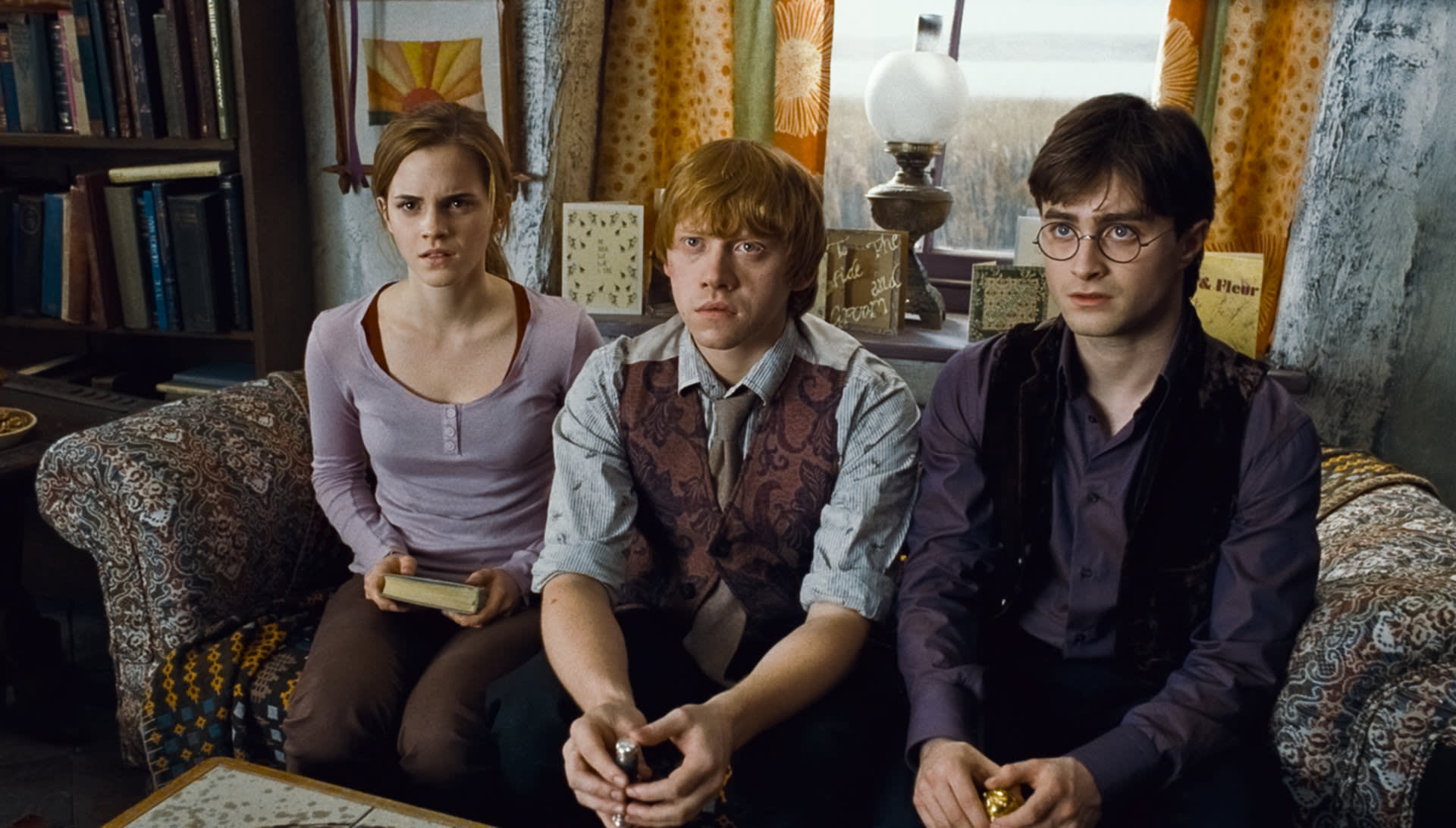 Harry Ron and Hermione sitting at the Burrow for Dumbledore's will 