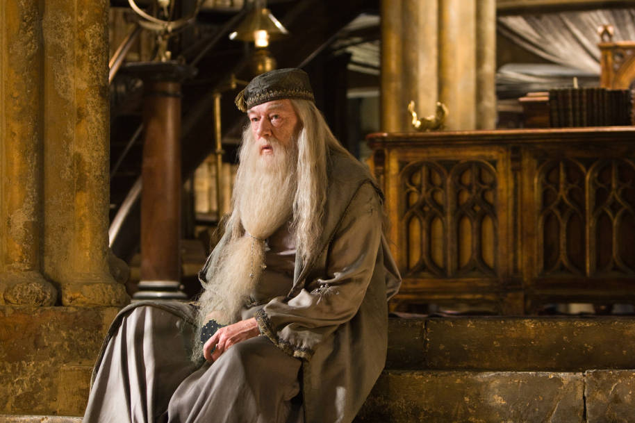 Albus Dumbledore is sat down on the steps in his office at Hogwarts.