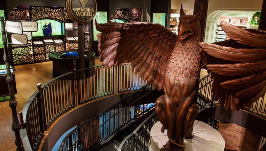 A photo of the griffin in the Harry Potter New York store. The griffin is the same as the one outside Dumbledore's office and is at the top of the stairs.
