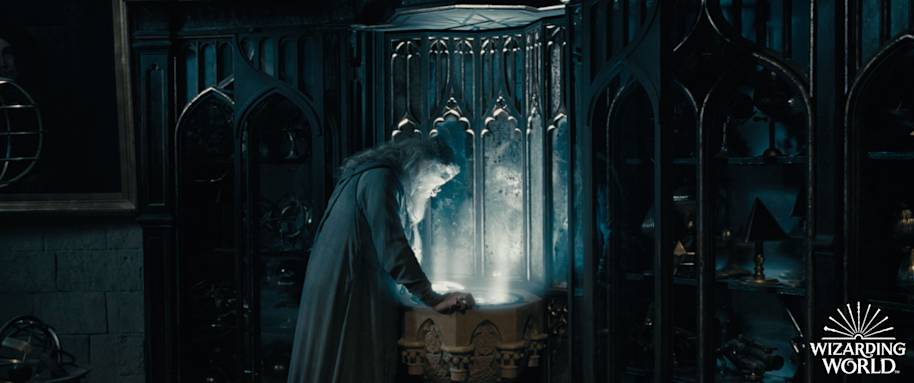 Dumbledore in his office looking into his Pensieve