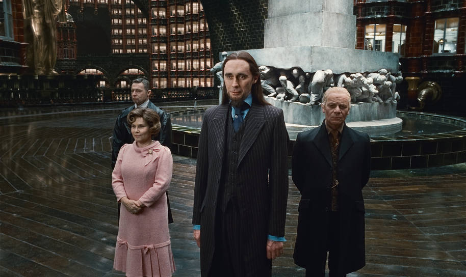 Dolores Umbridge, Albert Runcorn, Pius Thicknesse and another Ministry worker stand in front of the fountain in the Ministry of Magic.