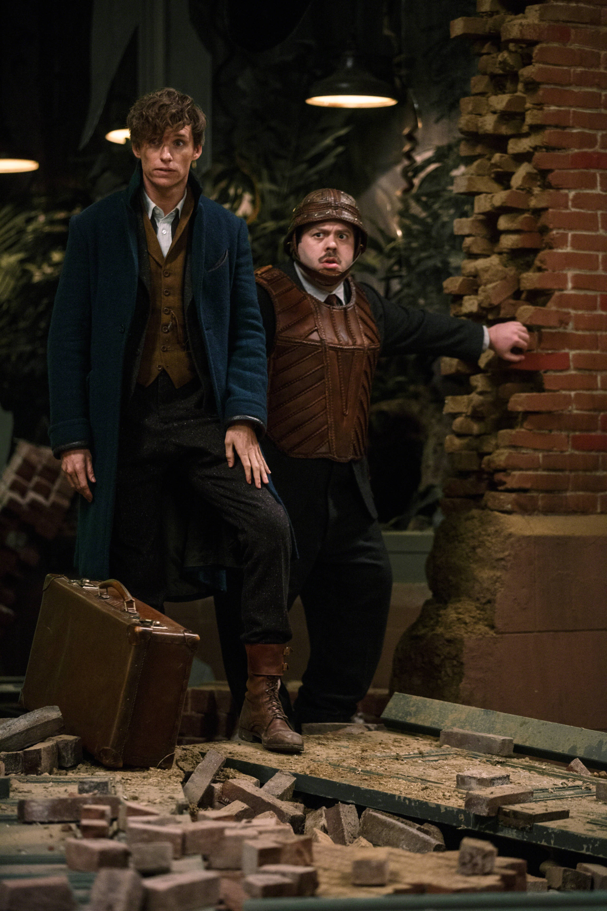 Newt Scamander and Jacob Kowalski survey a scene of destruction in Fantastic Beasts and Where to Find Them