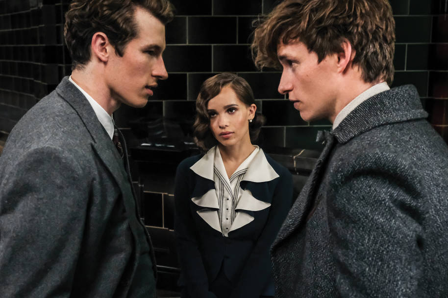 Theseus, Newt and Leta standing in the Ministry of Magic. Newt and Theseus are staring at each other while Leta stands between them.