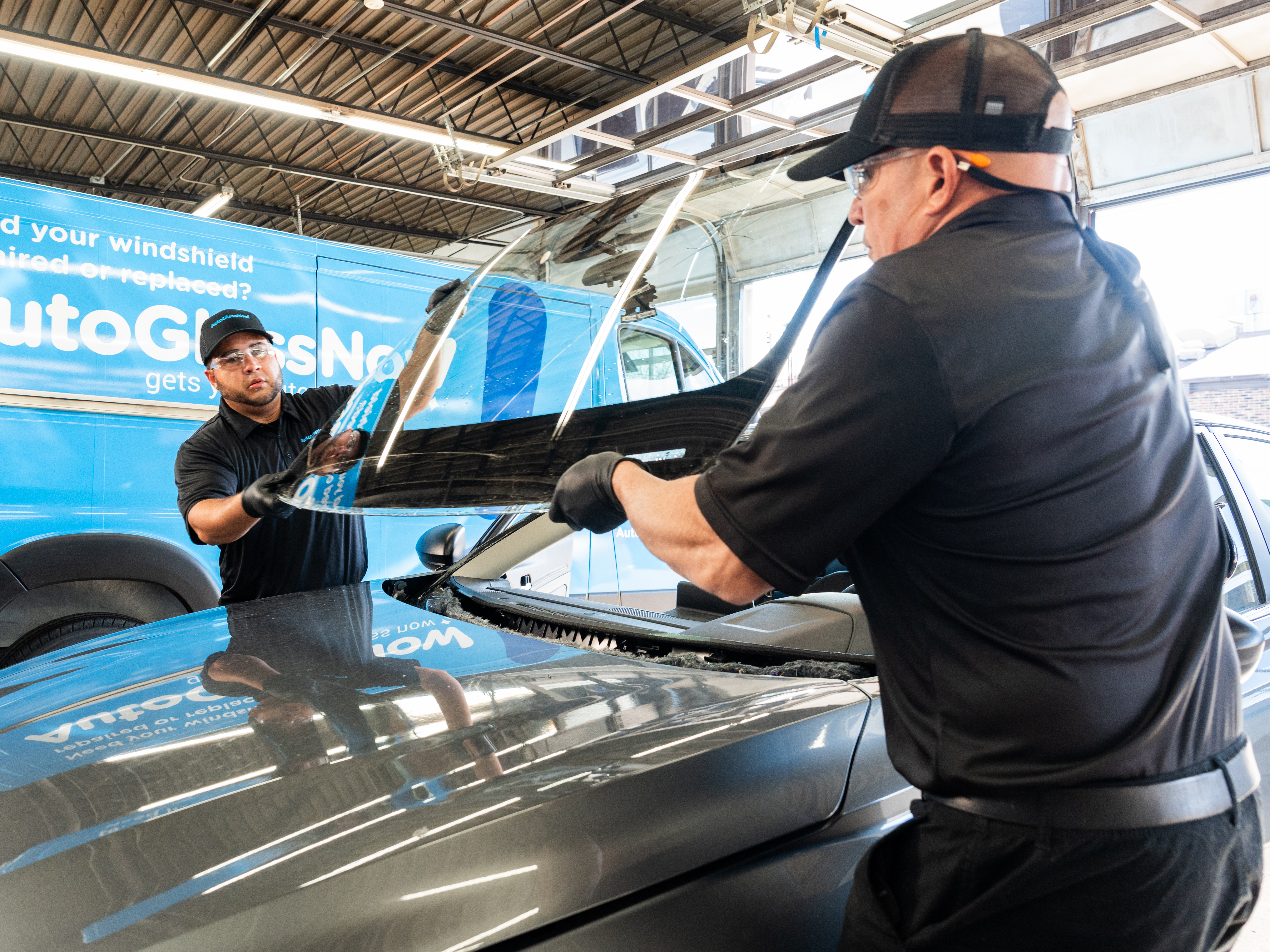 Auto Glass Now technicians fitting a windshield