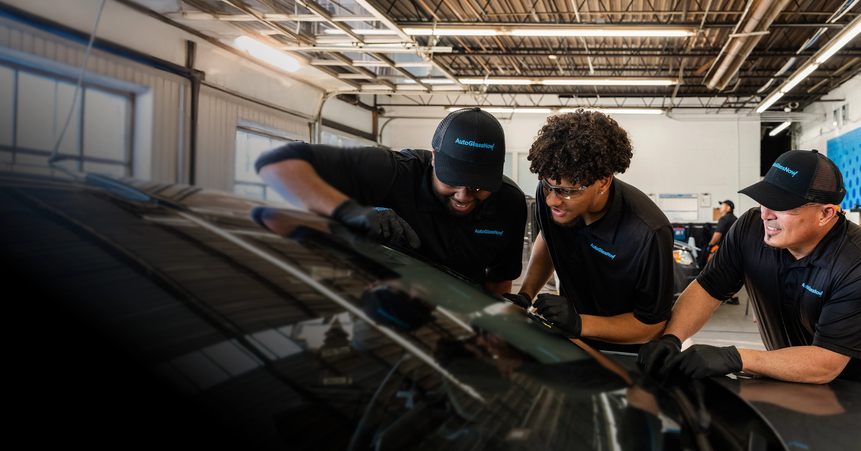 Technicians inspecting a windshield