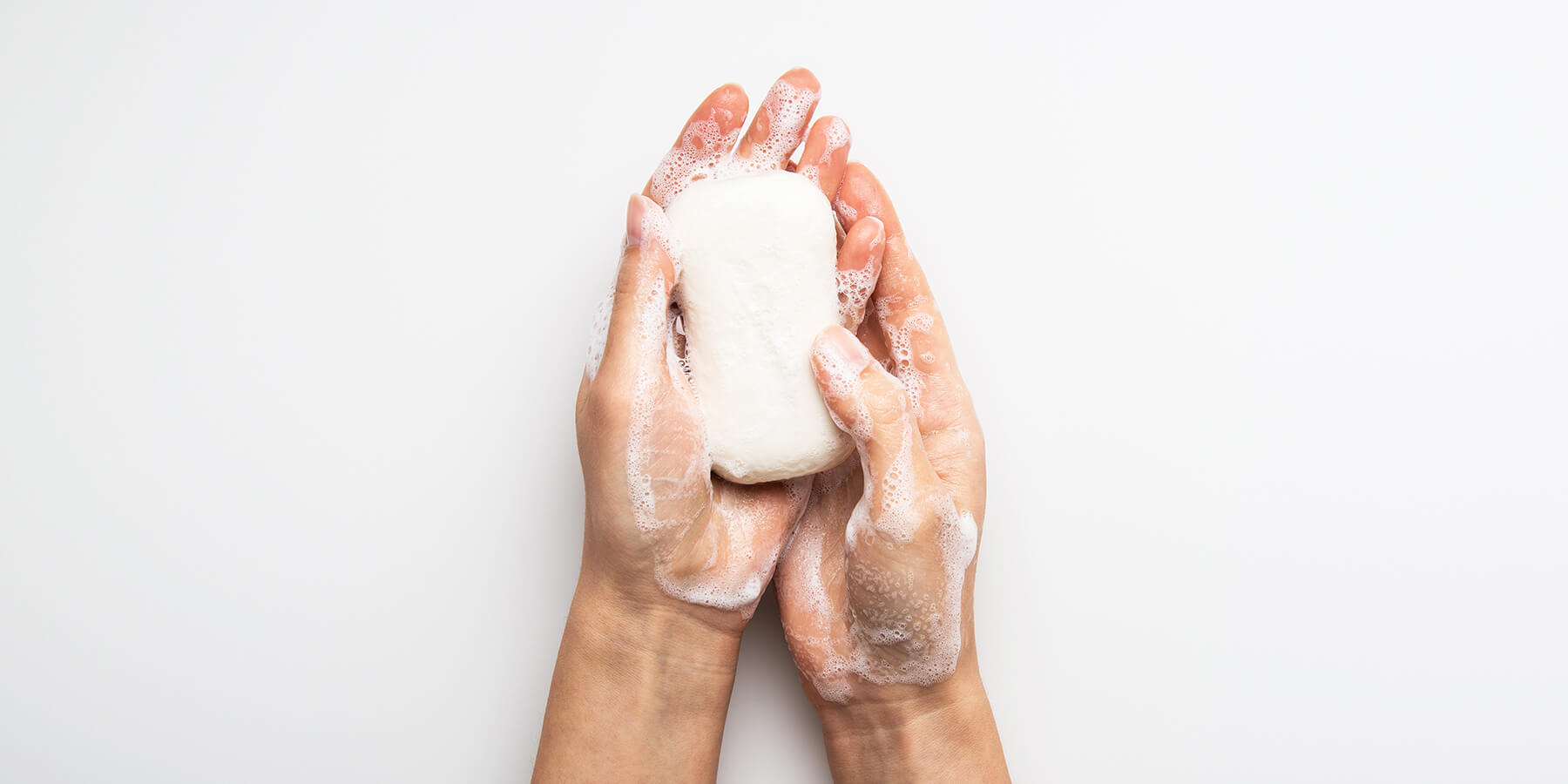 Person using soap to wash hands as a flu preventative 