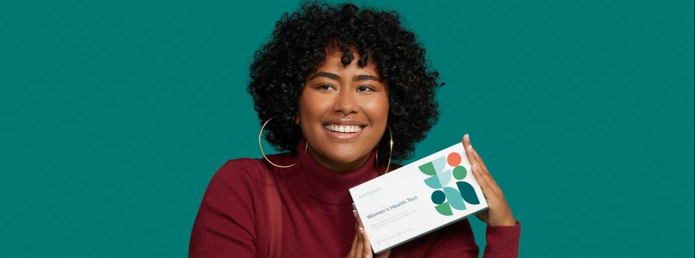 Woman holding women&#x27;s health test to check for hormone imbalance