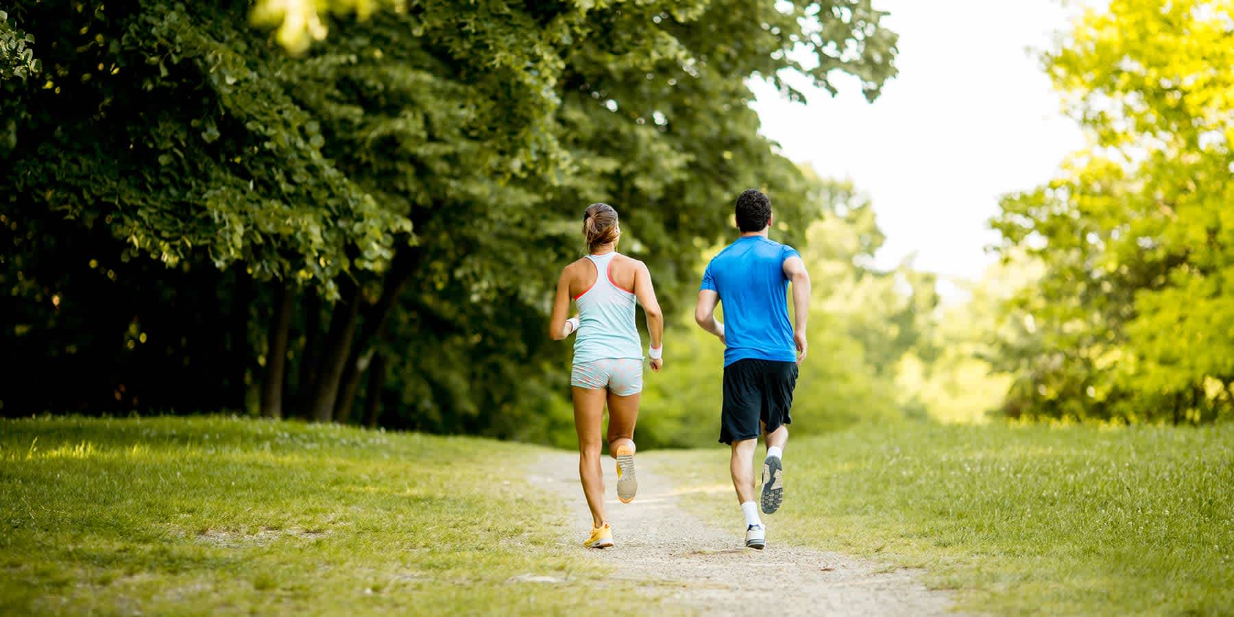 Two people jogging side by side to lose weight faster through physical activity