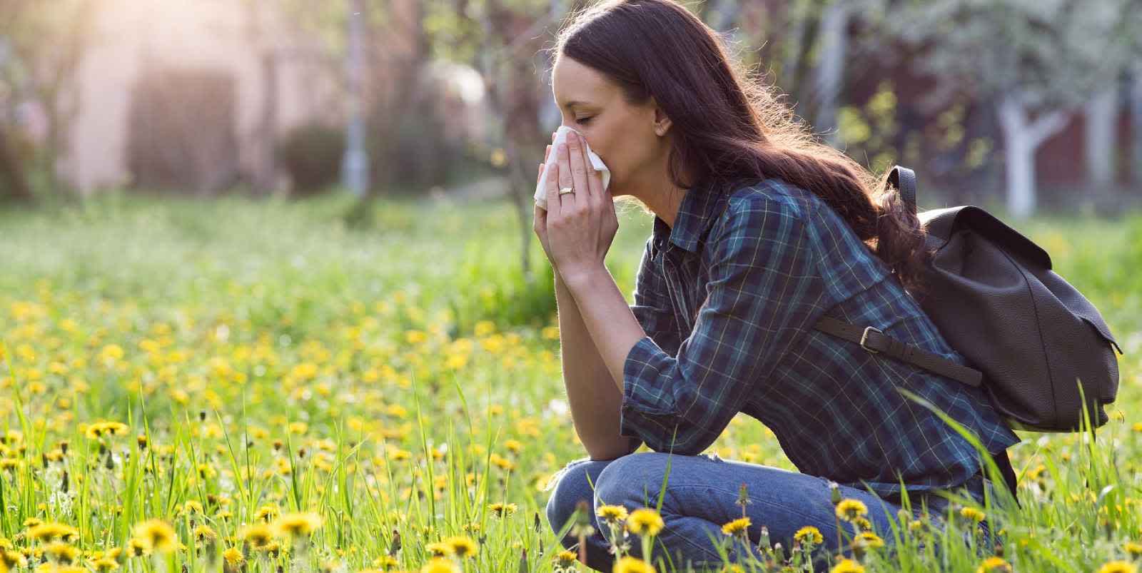 Woman hiking outdoors experiencing allergic reaction as a cause of inflammation