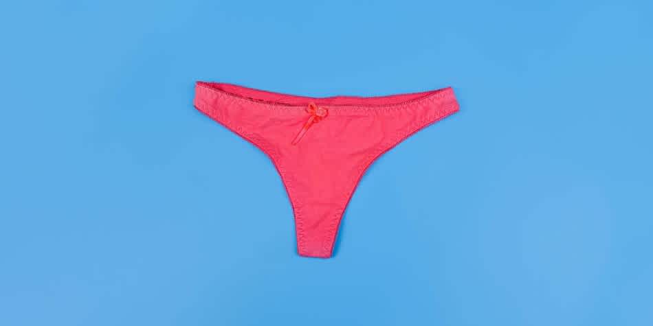 Woman's underwear against blue background that may have STD discharge