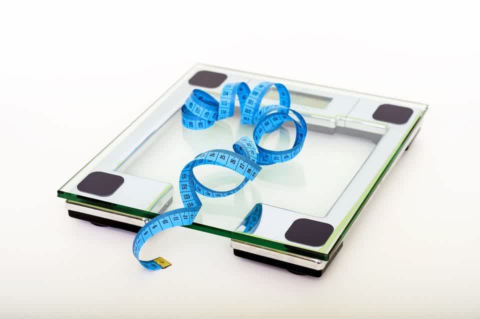 Bathroom scale and measuring tape for checking on weight loss with intermittent fasting